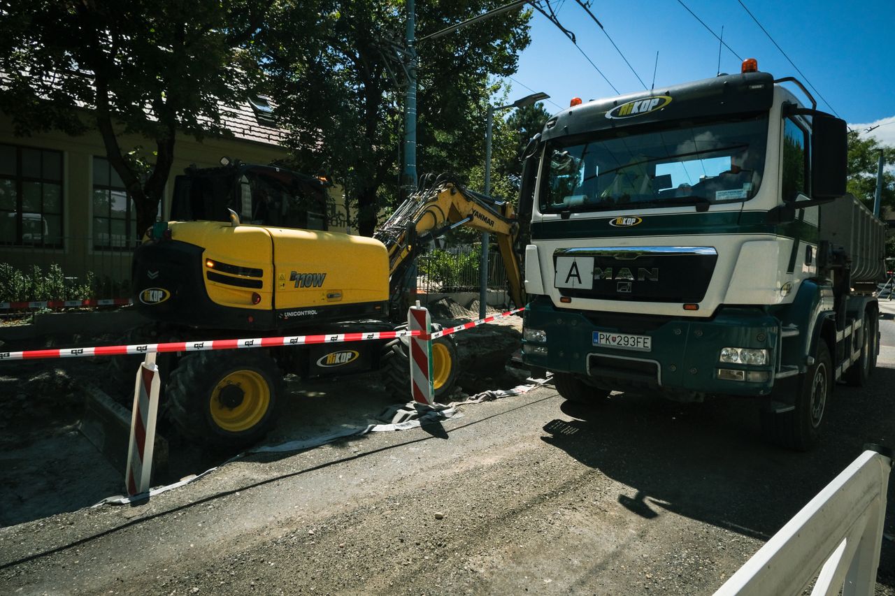 Road construction scene in Bratislava featuring heavy machinery, showcasing urban development.